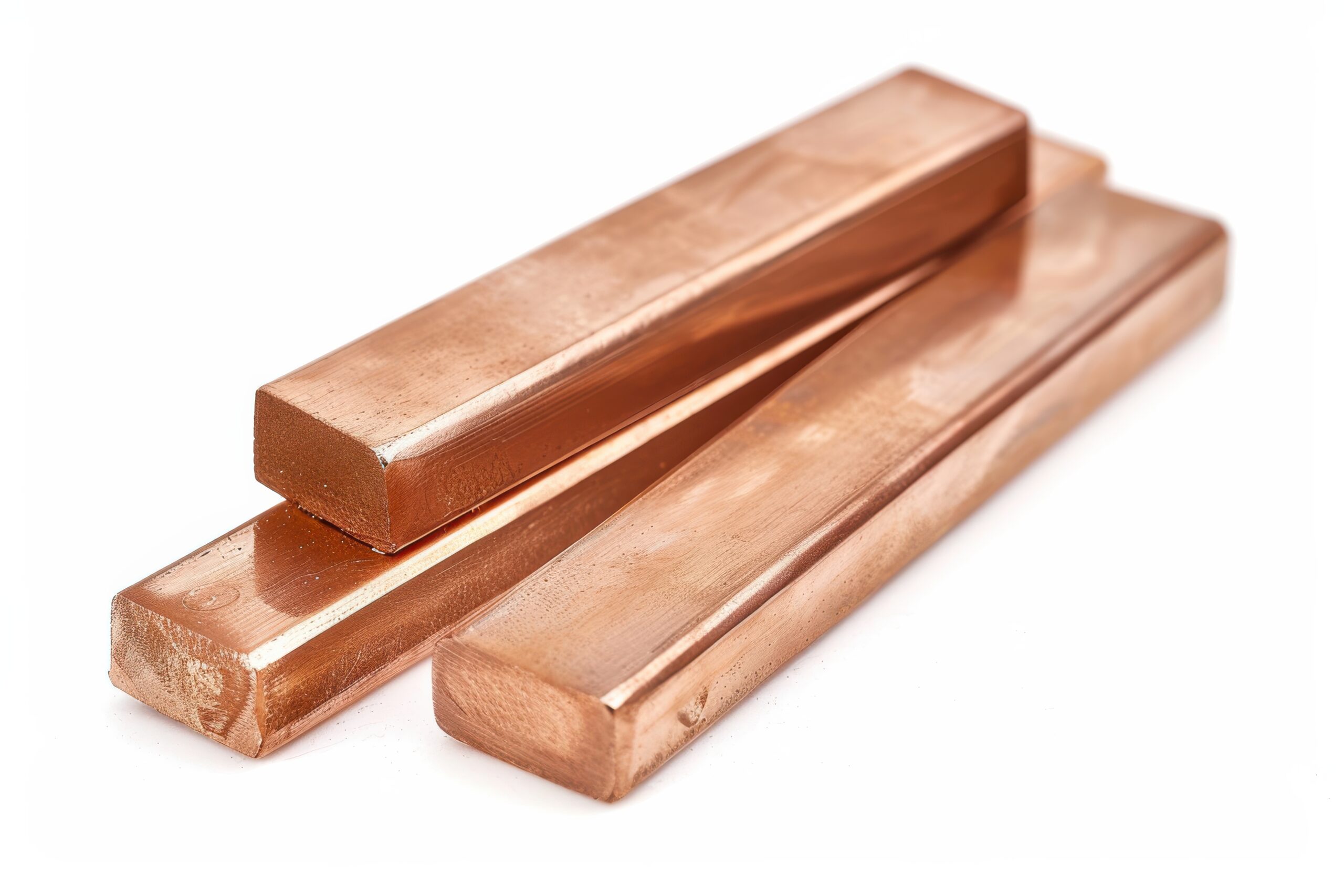 three shiny copper bars resting on a white surface